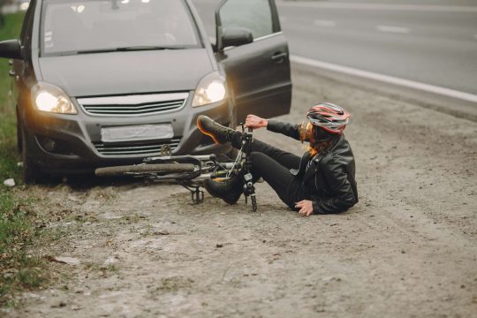 The woman crashed into the car. Girl in a helmet.